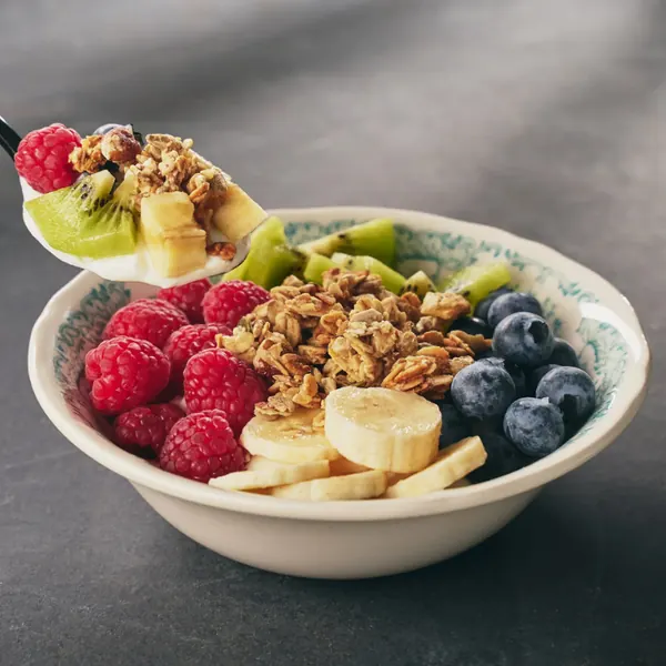 Bowl with granola, fresh fruit and yoghurt