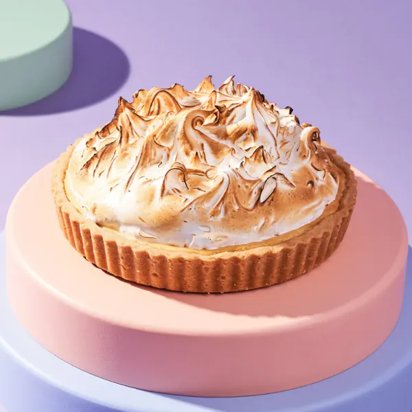 Lemon meringue tart on a pink pedestal