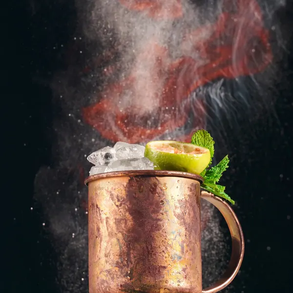 Moscow mule in a copper mug with smoke and lime