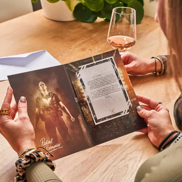 Two people paging through a magazine at a table